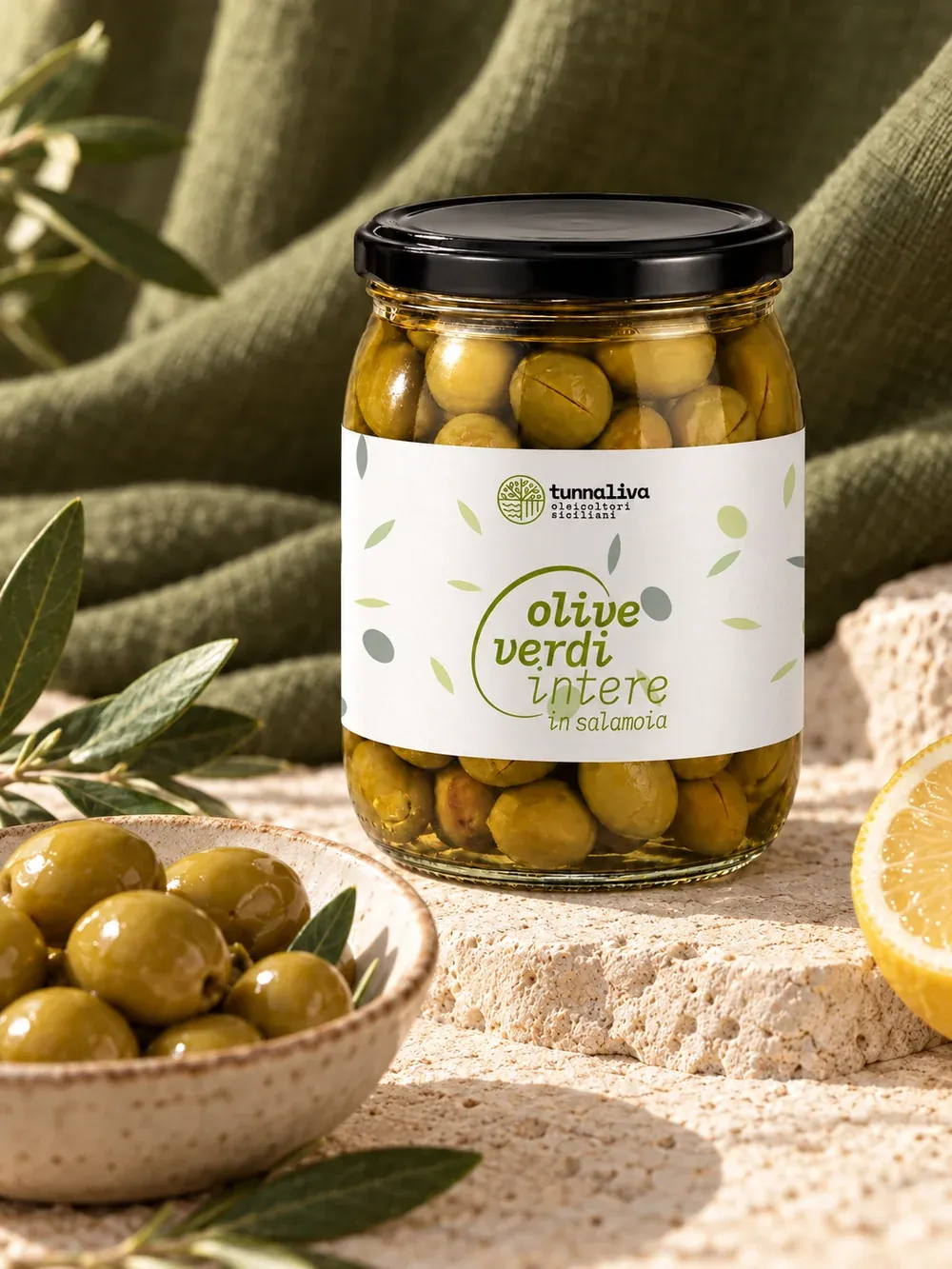 Jar of green olives with an aperitif bowl